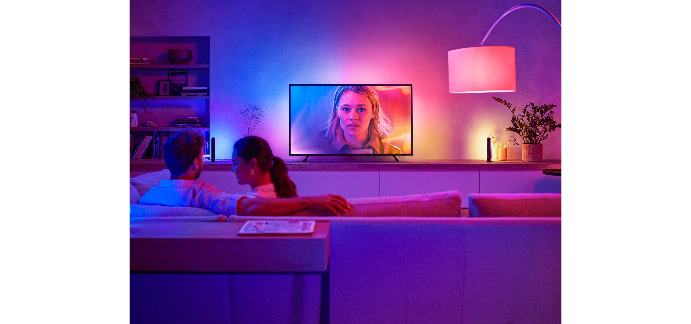 Philips Hue Play gradient lighting adding blue and pink accents around a living-room television